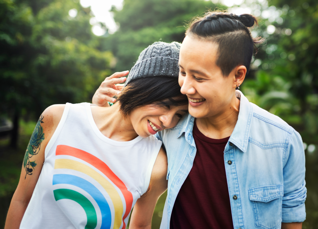 Smiling young couple standing outdoors
