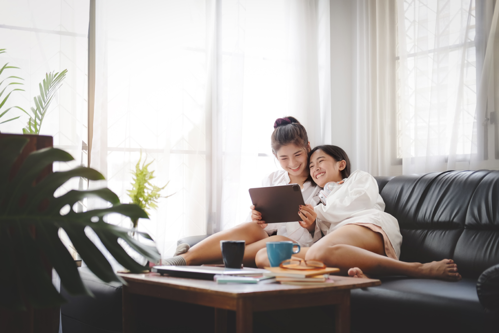 Asian women LGBT lesbian happy couple sitting on sofa